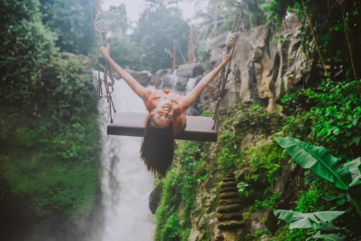 Beautiful girl having fun at the waterfalls in Bali