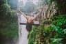 Beautiful girl having fun at the waterfalls in Bali