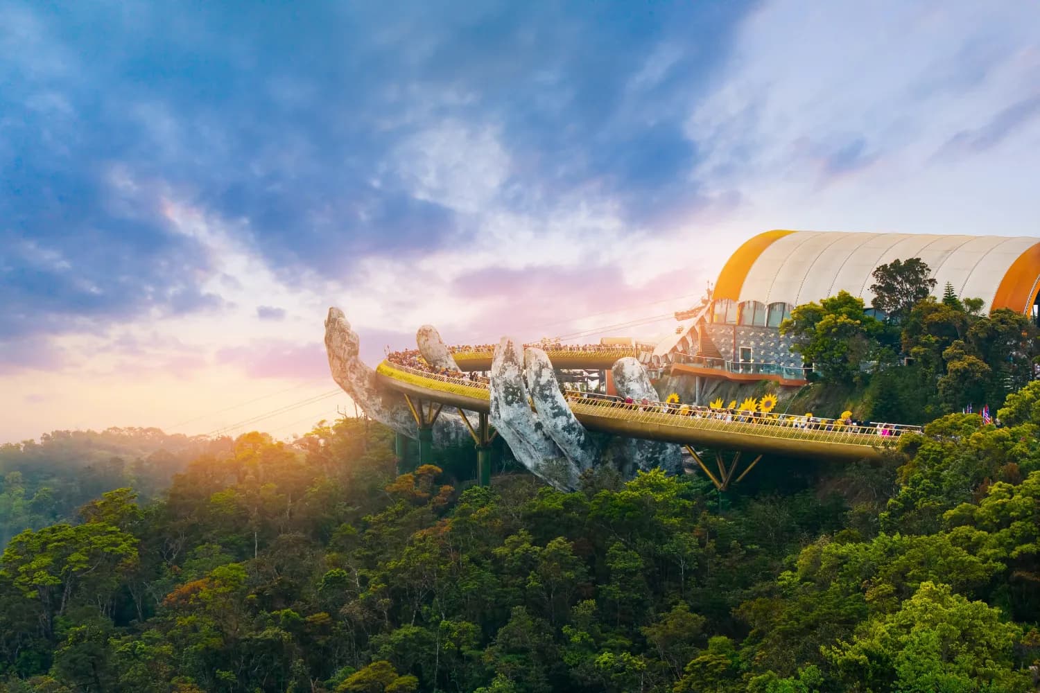 Golden bridge at ba na hills in Da nang Vietnam during sunset with scenic mountain views sunlight