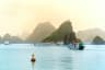 Beautiful Tourist cruise ship floating among limestone rocks at Ha Long Bay