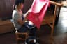Women worker paints batik in cotton cloth using wax or canting