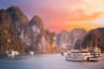 Scenic sunset over Halong bay, Vietnam with boats and limestone karsts