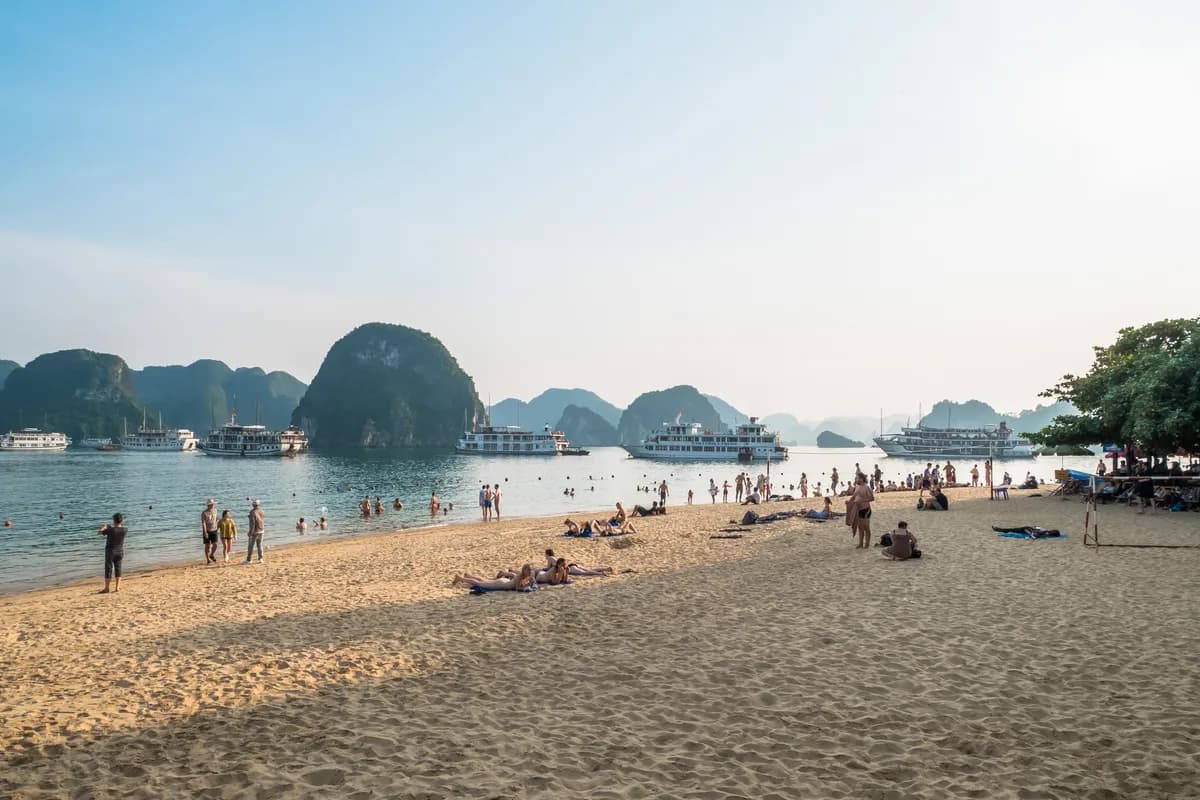 Tourists swimming and exploring beach in Ti Top Island