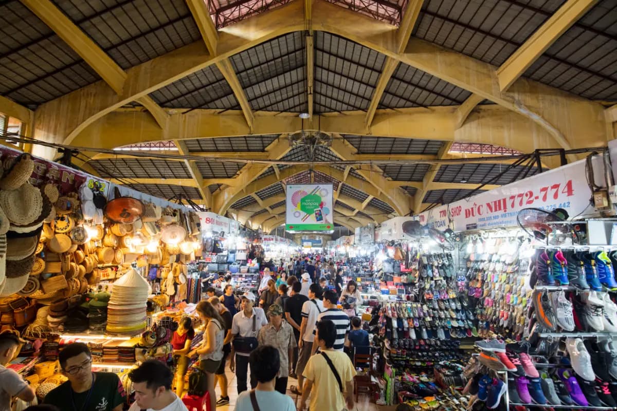 Ben Thanh Market surrounded by crowds and vibrant street activity