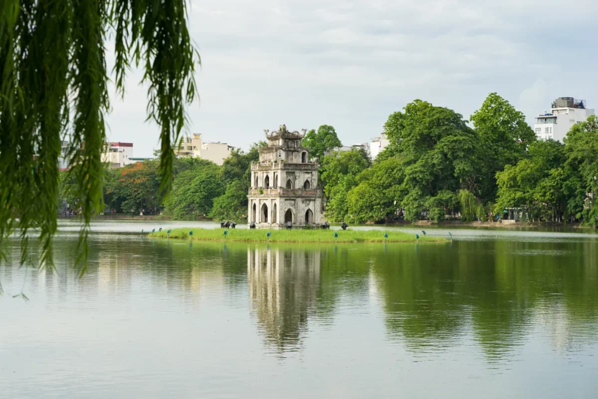 Hoan Kiem lake in Hanoi Vietnam with willow branches on foreground