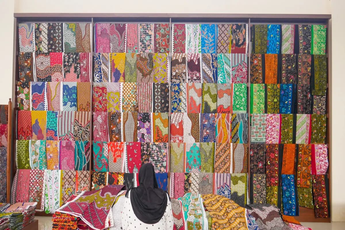 Rows of Batik Art cloth in various colors in a shop