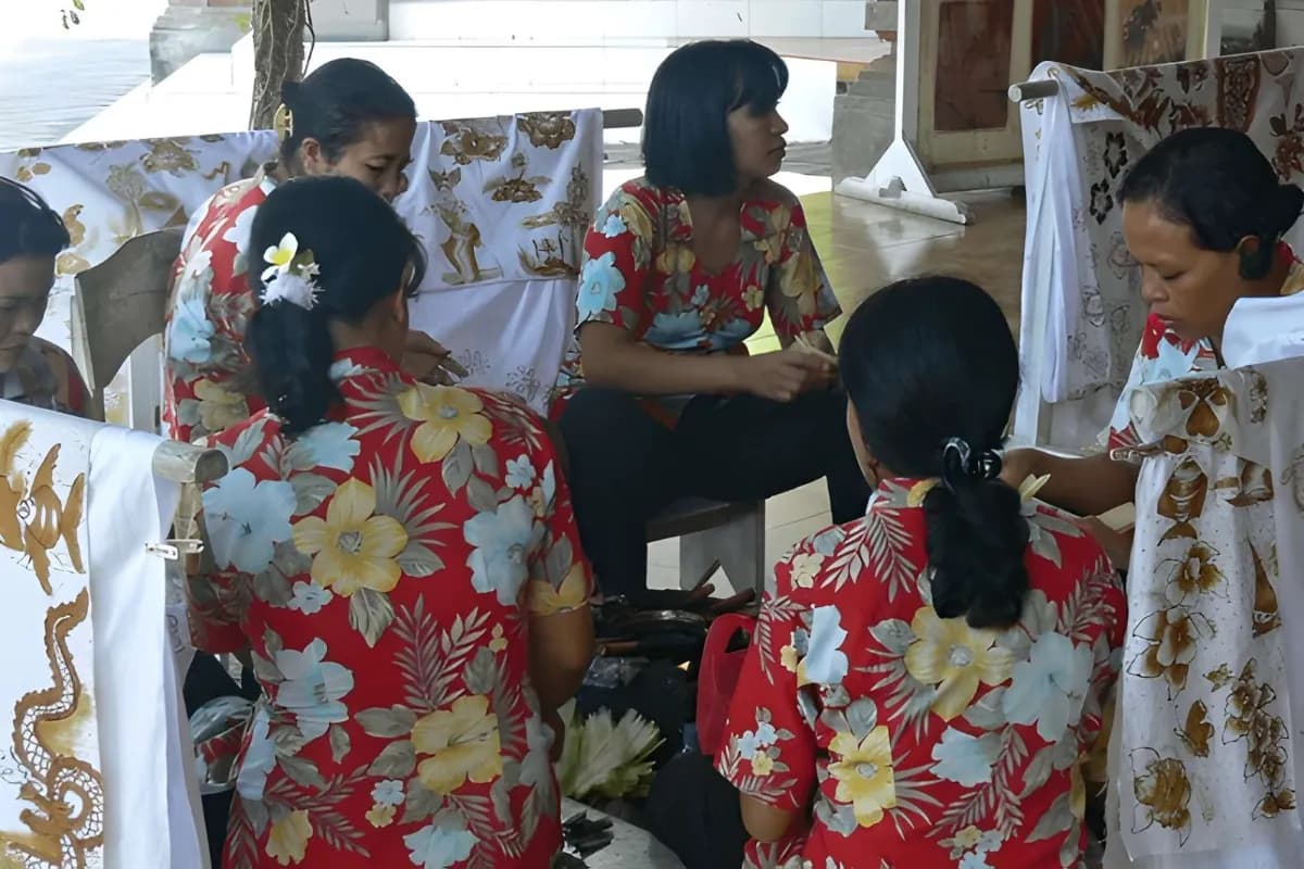 Batik Art in Bali by local women wearing red shirts with flowers
