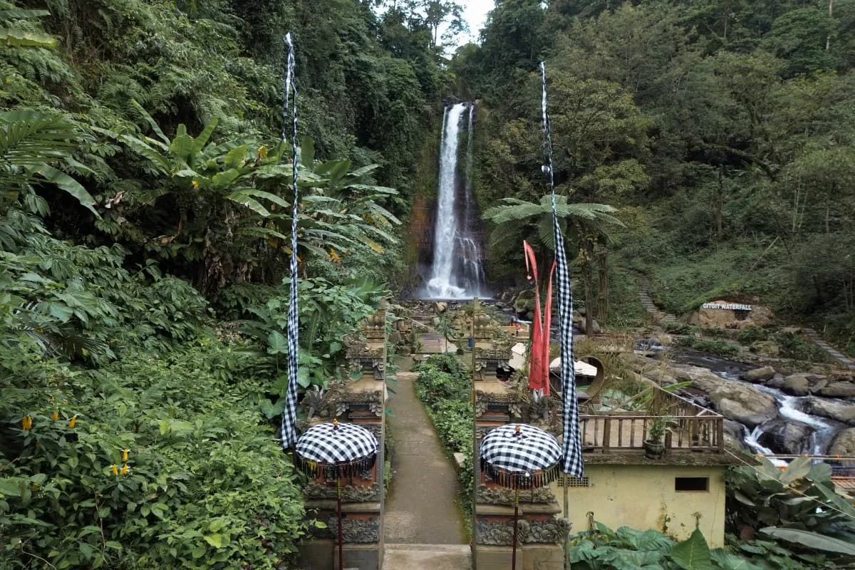 Aerial view of Gitgit waterfall in Buleleng, Bali, Indonesia with Balinese gate