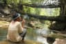 Person Smoking at Double Decker Living Root Bridge near Nongriat Village