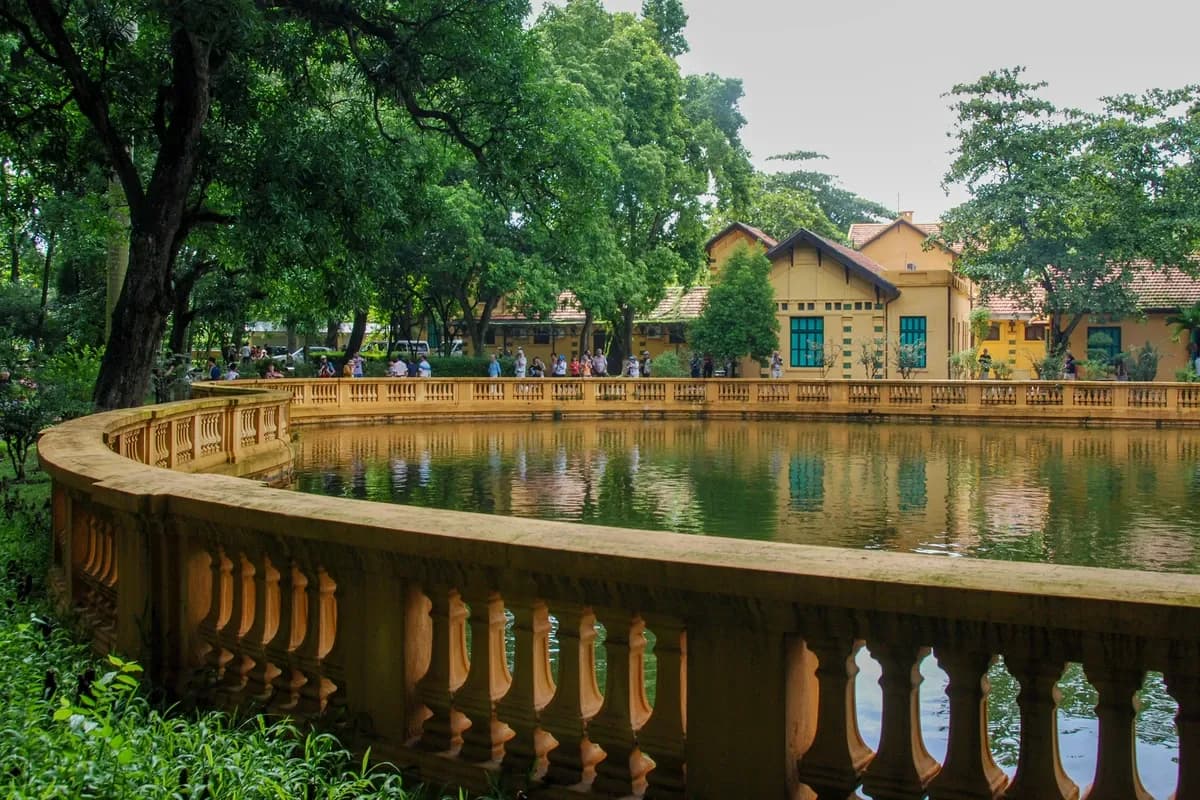 People walking near a lake at the Presidential palace gardens at Hanoi city