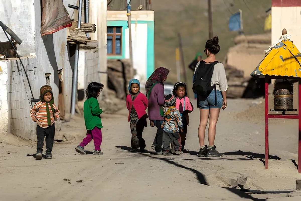 Kids surrounding Foreign Tourist in Mud village