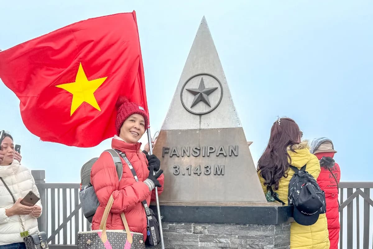 Female tourist and her pet Chihuahua dog on Fansipan mountain